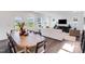 Inviting living room and dining area with hardwood floors, large windows, and comfortable, modern furnishings at 2019 Nebula Way, Durham, NC 27703