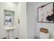 Neat powder room with pedestal sink, decorative mirror, and elegant wall art at 2019 Nebula Way, Durham, NC 27703