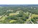 Beautiful aerial view of a property surrounded by green trees and a pond at 2139 Race Track Rd, Burlington, NC 27215