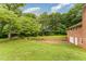 Large backyard with garage, swing set and lush green grass at 2139 Race Track Rd, Burlington, NC 27215