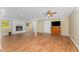 Spacious basement featuring hardwood floors, a white brick fireplace, and a ceiling fan at 2139 Race Track Rd, Burlington, NC 27215