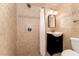 Tiled bathroom featuring a shower, toilet, and sink with a black cabinet at 2139 Race Track Rd, Burlington, NC 27215