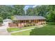 Charming ranch home with manicured front yard, brick facade, and screened in porch at 2139 Race Track Rd, Burlington, NC 27215