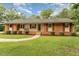 Charming single-story brick home featuring a well-manicured lawn and lovely front porch at 2139 Race Track Rd, Burlington, NC 27215