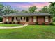 Charming single-story brick home featuring a well-manicured lawn and lovely front porch at 2139 Race Track Rd, Burlington, NC 27215