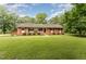 Inviting single-story home with lush front yard and covered porch, perfect for relaxing at 2139 Race Track Rd, Burlington, NC 27215