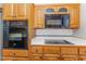 Modern kitchen showcasing stainless steel appliances, updated countertops, and oak cabinets at 2139 Race Track Rd, Burlington, NC 27215