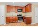Kitchen with stainless steel appliances, granite countertops, and warm wood cabinets at 2139 Race Track Rd, Burlington, NC 27215