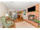 Open-concept living room with brick fireplace and connecting kitchen at 2139 Race Track Rd, Burlington, NC 27215