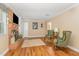 Comfortable living room with a brick fireplace and two green armchairs at 2139 Race Track Rd, Burlington, NC 27215