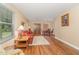 Cozy living room with hardwood floors, patterned sofa, and natural light, transitioning into dining area at 2139 Race Track Rd, Burlington, NC 27215