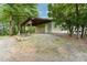 Shed featuring a covered outdoor space, gravel driveway, and surrounded by greenery at 2139 Race Track Rd, Burlington, NC 27215
