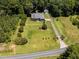 Beautiful home with manicured lawn, mature trees, and long driveway leading to detached garage at 2819 Russell Mcpherson Rd, Burlington, NC 27215