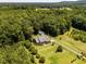 Aerial view of home featuring large lot, lush greenery, surrounded by dense trees and open fields at 2819 Russell Mcpherson Rd, Burlington, NC 27215