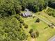 Aerial view of home featuring a large lot, lush greenery, and a detached garage at 2819 Russell Mcpherson Rd, Burlington, NC 27215