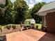 Brick patio with a small retaining wall and a white two-car garage at 2819 Russell Mcpherson Rd, Burlington, NC 27215