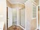 Bathroom with glass door shower, walk-in closet, decorative walls, and tile floor at 2819 Russell Mcpherson Rd, Burlington, NC 27215
