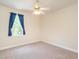 Neutral bedroom with ceiling fan, window with curtains and ample natural light at 2819 Russell Mcpherson Rd, Burlington, NC 27215