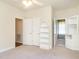 Neutral bedroom with ceiling fan, built-in shelves, and ample closet space at 2819 Russell Mcpherson Rd, Burlington, NC 27215