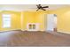 Bonus room with yellow walls, a fan, carpet, and built-in shelving at 2819 Russell Mcpherson Rd, Burlington, NC 27215