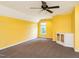 Spacious bonus room with yellow walls, carpet, and built in cabinet at 2819 Russell Mcpherson Rd, Burlington, NC 27215