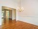 Elegant dining room featuring hardwood floors, a chandelier and wainscoting at 2819 Russell Mcpherson Rd, Burlington, NC 27215