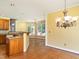 Open dining area featuring hardwood floors, a decorative chandelier, and natural light at 2819 Russell Mcpherson Rd, Burlington, NC 27215