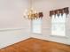 Bright dining area with hardwood floors, chandelier, and large windows with valence at 2819 Russell Mcpherson Rd, Burlington, NC 27215