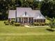 Charming brick home featuring a welcoming front porch and beautifully landscaped yard at 2819 Russell Mcpherson Rd, Burlington, NC 27215