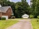 Exterior view of the rear of the house with a white garage and driveway at 2819 Russell Mcpherson Rd, Burlington, NC 27215