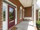 Inviting front porch with a decorative glass door and a cozy porch swing at 2819 Russell Mcpherson Rd, Burlington, NC 27215