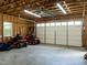 Inside view of two-car garage space, with riding lawn mowers and exposed studs at 2819 Russell Mcpherson Rd, Burlington, NC 27215