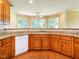 Kitchen featuring custom cabinets, granite countertops, white appliances, and hardwood floors at 2819 Russell Mcpherson Rd, Burlington, NC 27215