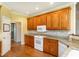 Well-equipped kitchen with granite countertops, white appliances, and custom wood cabinetry at 2819 Russell Mcpherson Rd, Burlington, NC 27215