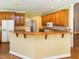 Kitchen featuring custom wood cabinets, a breakfast bar, and ample counter space at 2819 Russell Mcpherson Rd, Burlington, NC 27215