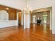 Spacious living room with hardwood floors and access to the outdoors, featuring an elegant chandelier at 2819 Russell Mcpherson Rd, Burlington, NC 27215