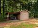 Exterior of a shed with lean-to and open storage area with trailer at 2819 Russell Mcpherson Rd, Burlington, NC 27215