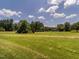 Expansive green lawn with trees in the distance at 2819 Russell Mcpherson Rd, Burlington, NC 27215