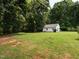 View of a large green yard with a shed and garage in the distance at 2819 Russell Mcpherson Rd, Burlington, NC 27215