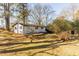 The backyard of the property shows a modest home exterior and grassy area at 3013 Avery St, Raleigh, NC 27610