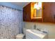 Small bathroom with white vanity, toilet, and tub with floral curtain at 3013 Avery St, Raleigh, NC 27610