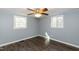 This bedroom has wood look floors, two windows and neutral paint at 3013 Avery St, Raleigh, NC 27610