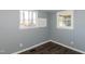 Bedroom featuring wood-look floors, neutral paint, and ample natural light from two windows at 3013 Avery St, Raleigh, NC 27610