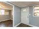 View of the interior front door and entrance featuring wood-look floors and gray painted walls at 3013 Avery St, Raleigh, NC 27610