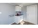 Functional laundry area with white cabinetry and countertop, near the back door at 3013 Avery St, Raleigh, NC 27610