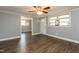 Living room showing the front door, multiple windows, wood-look floors, and neutral walls at 3013 Avery St, Raleigh, NC 27610