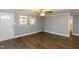 Spacious living room with wood-look floors and access to other areas of the home at 3013 Avery St, Raleigh, NC 27610