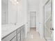 Elegant bathroom with double vanity, quartz countertops, glass-enclosed shower, and ample storage at 324 Longleaf Glen Court, Zebulon, NC 27597