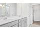 Bathroom featuring double vanity, white countertop, glass shower, with closet access at 324 Longleaf Glen Court, Zebulon, NC 27597