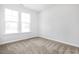 Bright bedroom featuring neutral carpet, two windows that provide plenty of natural light and neutral walls at 324 Longleaf Glen Court, Zebulon, NC 27597